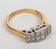 An 18ct yellow gold ring, set with twelve square cut diamonds mounted in white gold, 20th century, stamped "750" 6.9 grams total