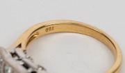 An 18ct yellow gold ring, set with twelve square cut diamonds mounted in white gold, 20th century, stamped "750" 6.9 grams total - 3