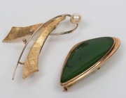 Two gold brooches, one 9ct gold set with New Zealand nephrite greenstone, the other 14ct gold set with&nbsp;cultured pearl and brilliant cut white diamonds, the larger 5.5cm wide