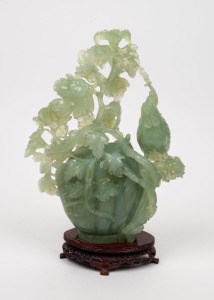 A Chinese carved jade ornament on wooden stand, 20th century, ​​​​​​​32cm high overall