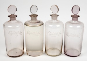 Set of four assorted point of sale glass jars with stoppers, 20th century, 28cm high.