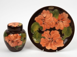 MOORCROFT&nbsp;"Hibiscus" pattern ginger jar and plate on brown grounds, (2 items), both impressed "Moorcroft, Made In England", the plate 26cm diameter
