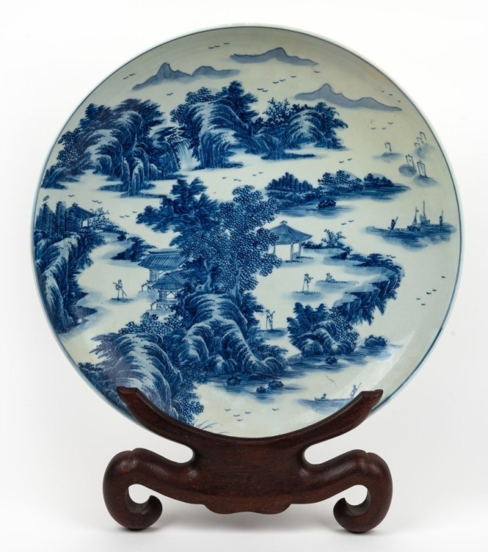 A Chinese blue and white porcelain charger on carved timber stand, Kangxi mark but most likely Republic period, 20th century, ​​​​​​​46cm diameter