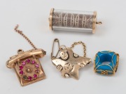 A 9ct gold and ruby telephone pendant, a 9ct gold star brooch, a gold mounted blue glass bead, and a 9ct gold mounted glass cylinder pendant with $100 bank note fragment, (4 items), ​​​​​​​the telephone and star brooch, 11.2 grams total