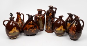 ROYAL DOULTON KINGSWARE&nbsp;eight porcelain whisky flagons, (all damaged), black factory mark to bases, the largest 25cm high