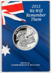 2013 Macquarie Mint "We Will Remember Them" folder containing the Australian $2 Remembrance coin, a 2g gold "We will Remember Them" piece, a Nauru $10 and a Kiribati $10, both in silver.