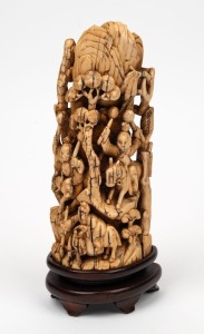 A Chinese carved mammoth ivory ornament on timber stand, depicting figures on horseback in mountain landscape, mid 20th century, 21cm high overall