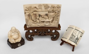 A Chinese carved ivory panel, seated Buddha statue, and book ornament, all on timber stands, mid 20th century, (3 items), ​​​​​​​the panel 17.5cm wide