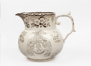 An antique English harvest jug, profusely adorned with limericks and vignettes, mid 19th century, 23cm high, 28cm wide