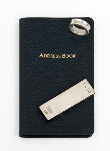 TIFFANY & Co. address book in box with original business card (unused), together with a sterling silver money clip and ring, both stamped "Tiffany & Co." with original box and pouch, (3 items)