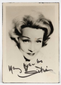 MARLENE DIETRICH signature in black felt tip pen, mounted on wood block. 9 x 12.5cm overall. 