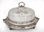 An antique English silver plated meat cover with engraved crest on warming stand, mid 19th century, an impressive 40cm high, 70cm wide, 45cm deep