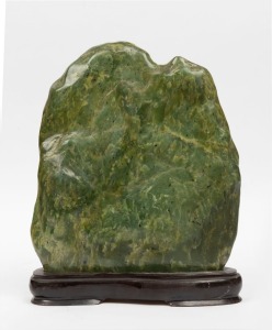 A Chinese jadeite scholar's stone on carved wooden base, 38cm high overall