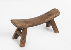 An antique Chinese timber opium pillow, 19th century, 14cm high, 30.5cm wide