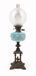 An antique oil lamp with case metal pagoda base, blue pressed glass font, Duplex black button double burner and chimney with later frosted glass shade, 19th century, 71cm high overall