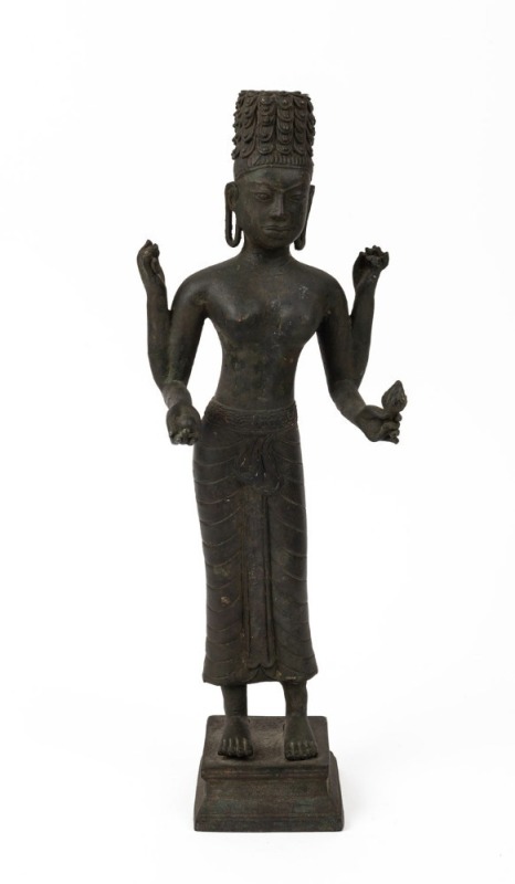 An antique Khmer cast bronze standing figure of the Hindu god Harihara, a combination of Vishnu and Shiwa, finely cast with detailed hair locks and realistic facial features, holding attributes in each hand, supported by a double square shaped pedestal ba