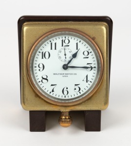 WALTHAM antique American travelling timepiece with enamel dial, Arabic numerals, crown wind and time set below the 6, mounted to a bakelite stand, early 20th century, 14cm high