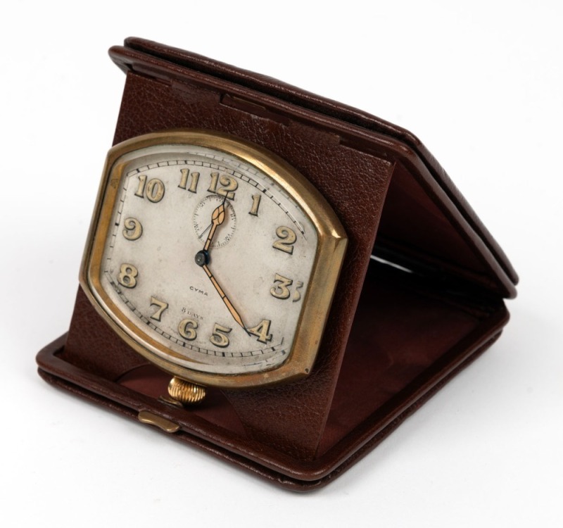 CYMA attractive vintage Swiss travel clock in original brown folding wallet, early 20th century, the wallet 11cm high