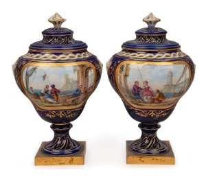 SEVRES pair of antique French porcelain urns with hand-painted scenes on blue grounds with gilt highlights and ormolu bases, 19th century, blue factory marks inside the lids, 18cm high