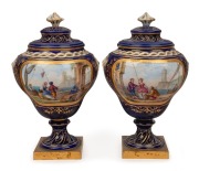SEVRES pair of antique French porcelain urns with hand-painted scenes on blue grounds with gilt highlights and ormolu bases, 19th century, blue factory marks inside the lids, ​​​​​​​18cm high
