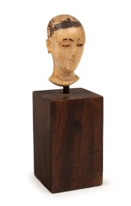 An antique Chinese carved ivory head with remains of painted decoration, 17th/18th century, 5.5cm high, 14cm high including stand