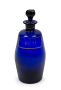 A Georgian rum decanter, Bristol blue glass with hand-painted gilt label, 18th/19th century, 20cm high