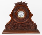 An antique mantle clock in timber case with carved oak leaf decoration, French timepiece with platform escapement,19th century, 42cm high