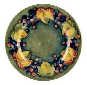 MOORCROFT "Leaf and Berry" pottery plate on celadon ground, impressed signature mark "Moorcroft, Potter to H.M. The Queen", 24cm diameter