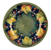 MOORCROFT "Leaf and Berry" pottery plate on celadon ground, impressed signature mark "Moorcroft, Potter to H.M. The Queen", 24cm diameter
