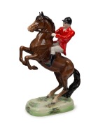 BESWICK English porcelain statue of a huntsman on rearing horse, black factory mark to base, 24cm high