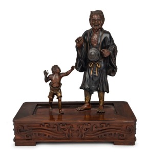 An antique Japanese bronze figural group, mounted on a rosewood base, Meiji Period, 19th/20th century, ​​​​​​​29cm high