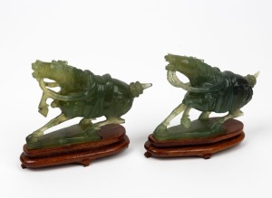 A pair of Chinese jade horse statues on carved wooden bases, 20th century, ​​​​​​​11cm high