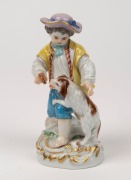 MEISSEN antique German porcelain statue of a boy with a dog, 19th century, blue crossed swords mark to base, 12.5cm high