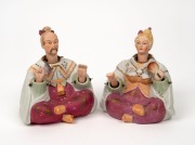A pair of bisque porcelain "Nodding Head" seated statues, early 20th century, ​​​​​​​13cm high