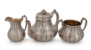 An antique English Aesthetic Movement three piece sterling silver tea service stamped "HUNT & ROSKELL LATE STORR MORTIMER & HUNT", made in London, circa 1889, the pot 17cm high, 1370 grams total