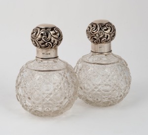 A pair of sterling silver and hobnail cut crystal bottles, made in Birmingham, circa 1912, 14cm high