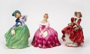 ROYAL DOULTON&nbsp;three porcelain figures of ladies, comprising "Autumn Breezes" (HN&nbsp;1913); "Victoria" (HN 2471) and "Top O' The Hill" (HN 1834), the largest 18cm high