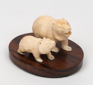 A Japanese carved ivory bear figure group mounted on rosewood base, early to mid 20th century, 5cm high, 9cm wide overall