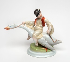 HEREND Hungarian porcelain statue of a boy riding a goose, 20th century, blue factory mark to base, 21cm high