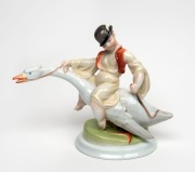 HEREND&nbsp;Hungarian porcelain statue of a boy riding a goose, 20th century, blue factory mark to base, 21cm high