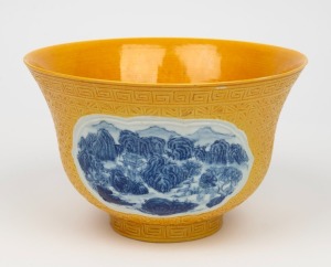 A Chinese yellow ceramic bowl adorned with underglaze blue landscape vignettes, 20th century, square seal mark to base, 13cm high