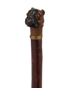 An antique walking stick with carved dog's head handle with glass eyes, brass collar, blackthorn shaft and brass ferrule, 19th century, 87cm high