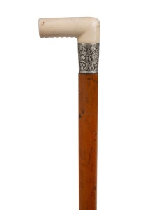 An antique walking stick with ivory handle, silver collar with foliate decoration, Malacca shaft and brass ferrule, 19th century, 89cm high