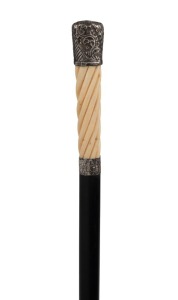 An antique walking stick with carved ivory handle, silver top and collar, ebony shaft and brass ferrule, 19th century, 93cm high
