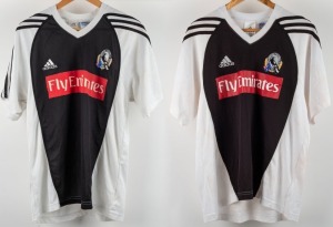 ex NATHAN BUCKLEY COLLECTION:&nbsp;Collingwood training/T-shirts, circa 2006. White with black front and black stripes on sleeves. Red &lsquo;Fly Emirates&rsquo; patch across middle, with adidas and Collingwood logos above. Wizard logo to rear of one. (2 items).
