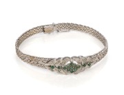 An Art Deco 18ct white gold and emerald bracelet, 20th century, stamped "750", maker's marks illegible, 23.5 grams