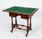 An antique English mahogany fold-over games table with carved stretcher base, circa 1880, 74cm high, 62cm wide, 42cm deep, (83cm open)