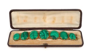 An antique 22ct gold bracelet, set with seven graduated polished malachite stones, housed in original plush fitted leather box, early to mid 19th century, ​​​​​​​17cm long