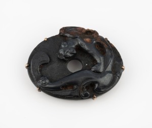 An antique Chinese carved hard stone bat amulet, 15th/16th century, set as a buckle in gold and silver in the early 20th century, stamped "K18. SBD", 4.5cm wide