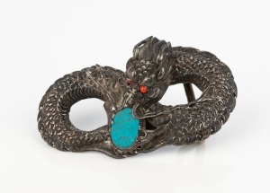 An antique Chinese silver dragon buckle with turquoise and coral, early 20th century, ​​​​​​​8cm wide